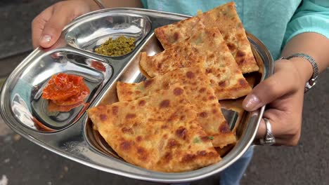 alu and pyaz paratha served with mango and chilly pickle