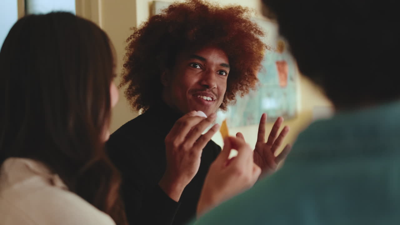 People having a conversation and eating snacks