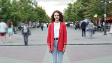 woman in a red jacket on a city street