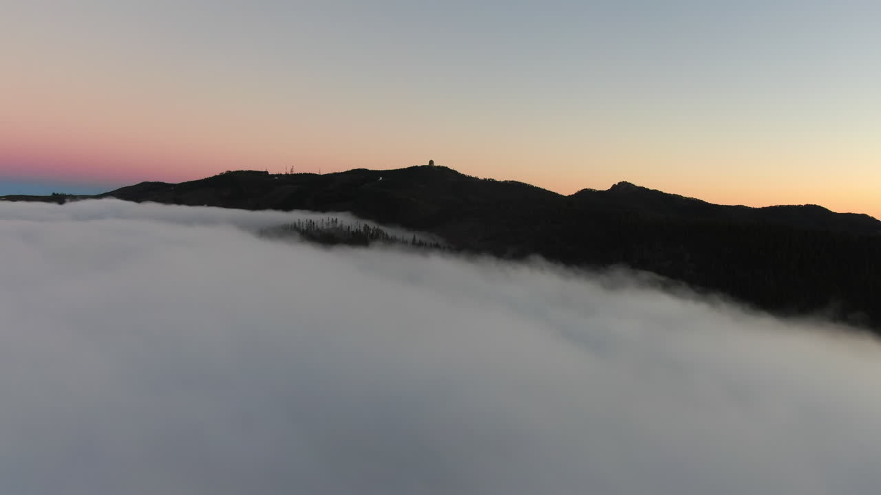 Flying through the clouds on the island of Gran Canaria during a magical sunset