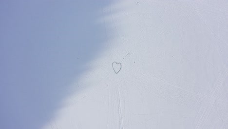 amazing outdoors artwork - huge heart made of frozen ice sculptures - hope and love - descending aerial rotating in the end, hitting centre of heart