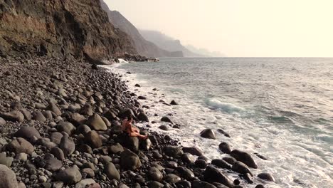 Idyllic-scene-of-two-people-at-unspoiled-virgin-beach-in-Gran-Canaria,-Spain-during-summer-time-on-vacations