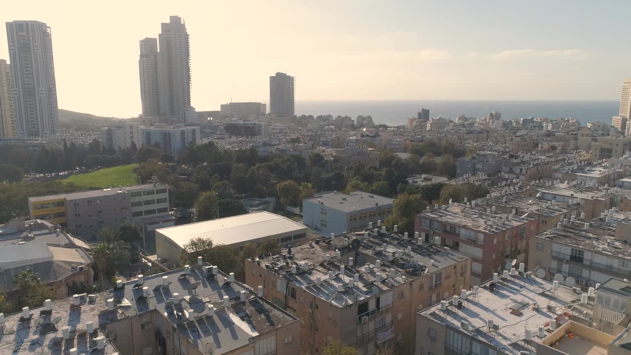 Aerial view of the coastal town of Bat Yam on the shores of the Mediterranean Sea as panorama skyline and urban seascape at sunset, Israel. Top view of residential city view middle east Buildings and streets shot houses at the horizon.
