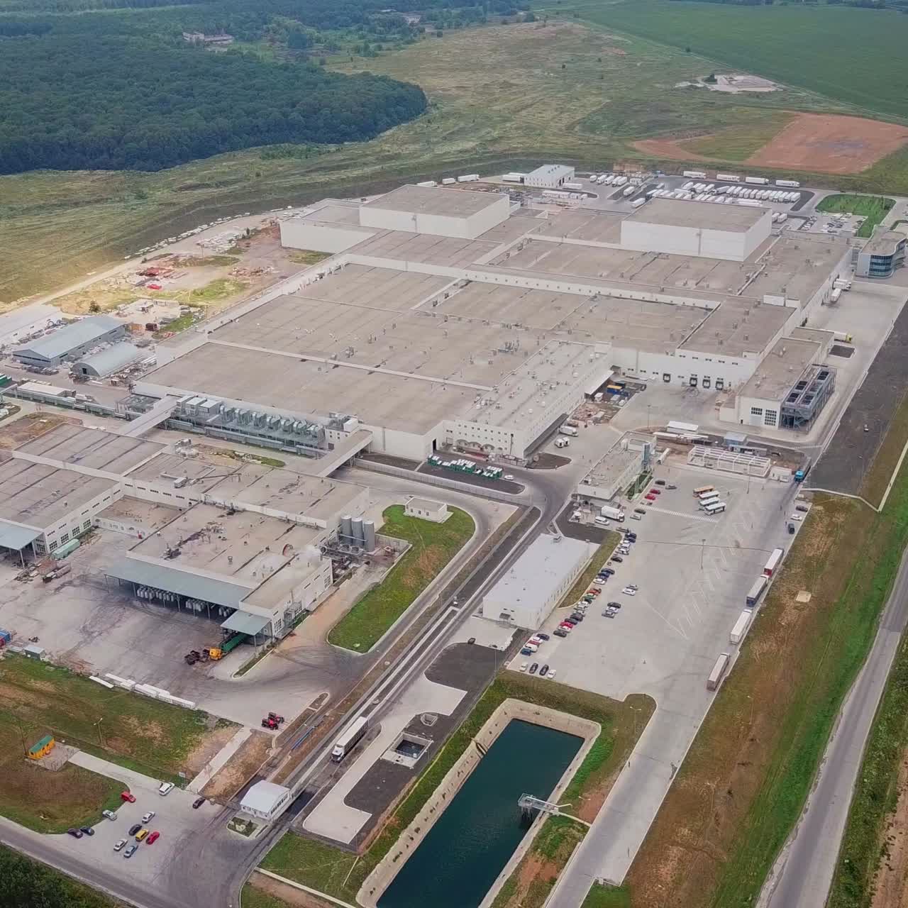 view on the factory of floorboard manufacturing that is located out the city in the field. Aerial view
