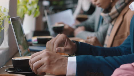 businessman using digital laptop computer in cafe drinking coffee working browsing emails networking online enjoying internet connection