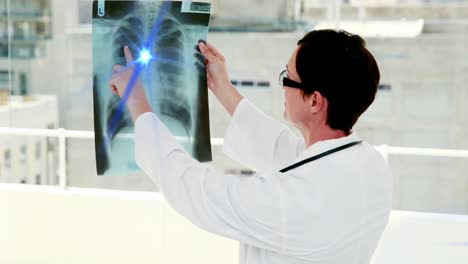 animation of light moving over caucasian female doctor with x ray photo