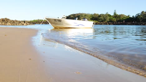 a boat gradually approaches and lands on a beach