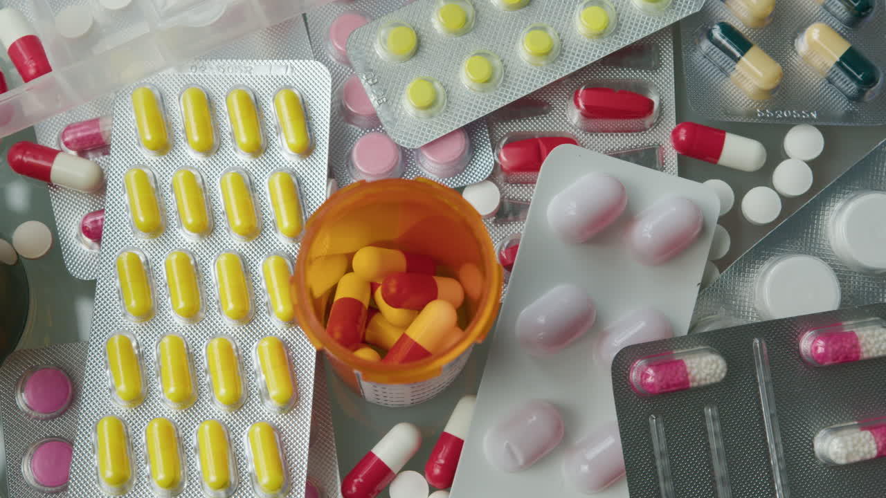 Close-Up of Various Medications, Pill Bottles and Blister Packs on the Table