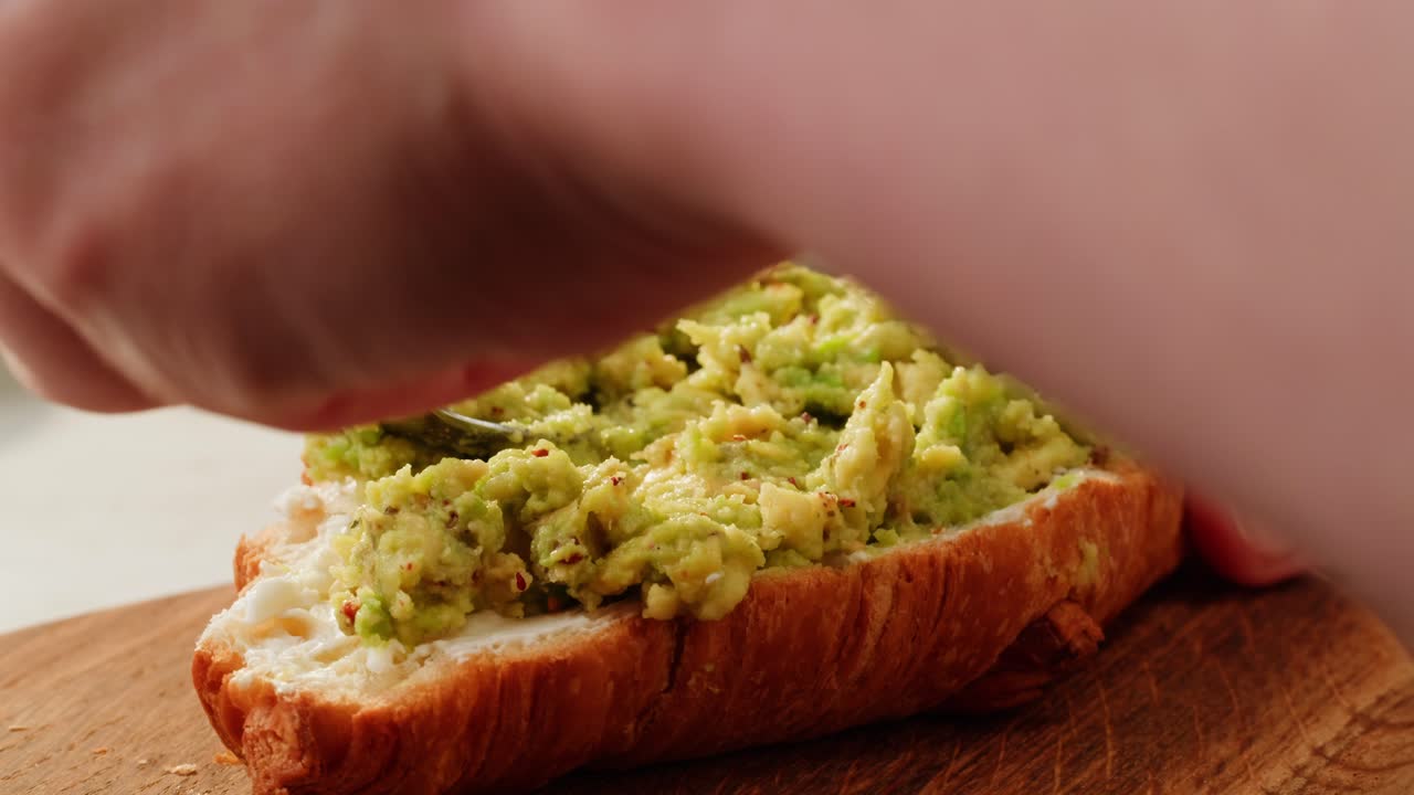 Preparing a Delicious Avocado Croissant Sandwich