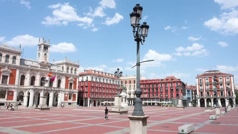 panoramic sunny view of the historic plaza mayor in valladolid, spain’s first permanent square, with the town hall on a hot summer day against a blue sky.