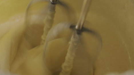 close-up of an electric mixer mixing batter