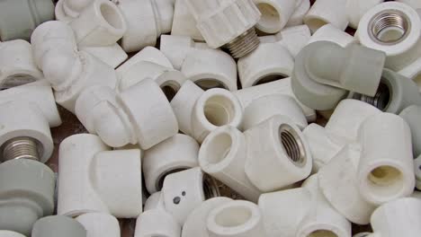 many white pvc water supply pipe fittings close up