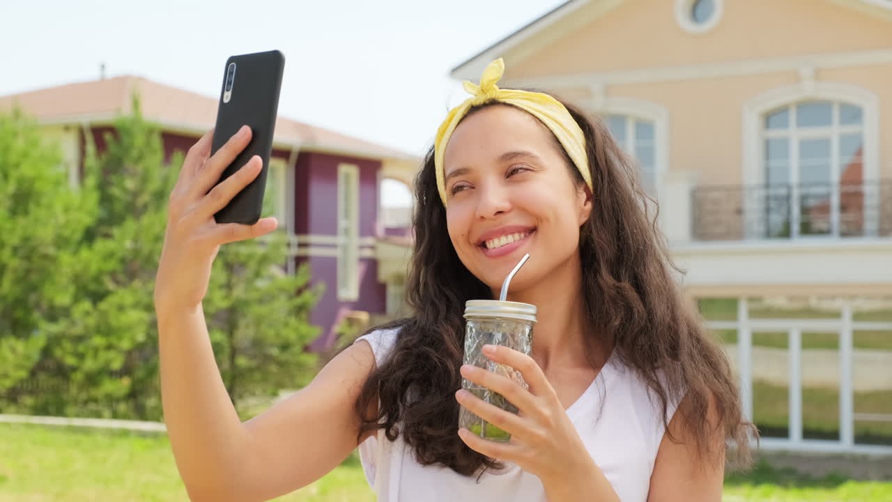 Young Woman Taking Selfie With Lemonade Glass