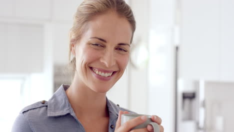 Woman-drinking-coffee-and-smiling-at-camera-in-close-up-slow-motion-portrait