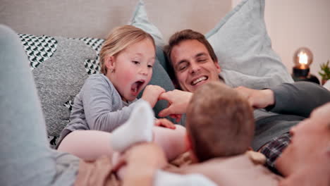 family, play and laughing on bed with tickling