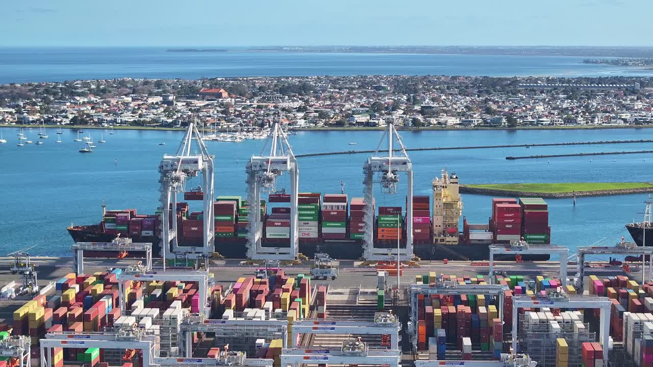 Aerial view of cranes loading container ships at Melbourne’s Victoria International Container Terminal in Port Phillip Bay
