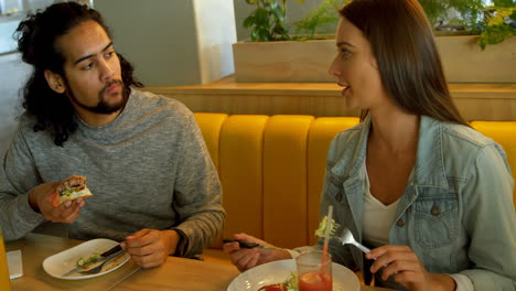 couple interacting while having food 4k