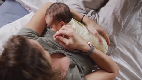 Video-of-happy-caucasian-mother-feeding-newborn-baby