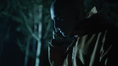 man talking on phone in the night forest