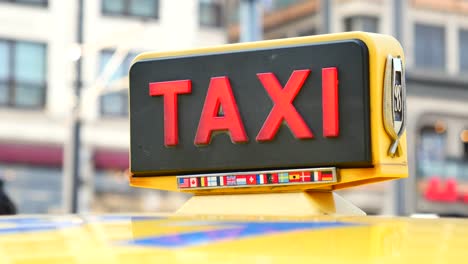 close-up of a taxi sign with international flags