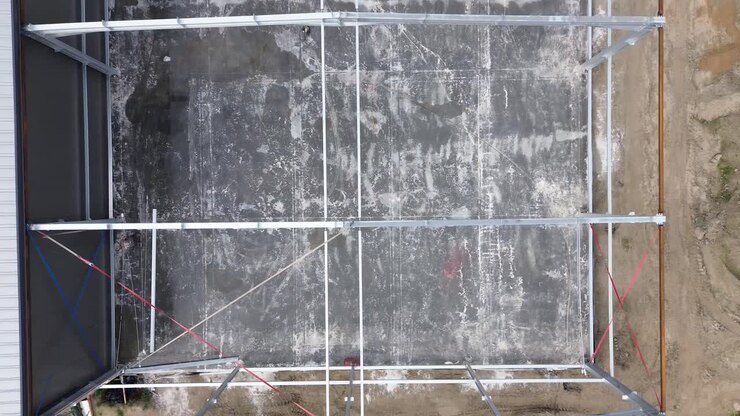 Drone view showcases precise construction of an industrial hall—a strategic symphony of structural progress in this insightful stock footage