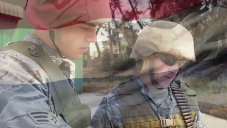 digital composition of waving germany flag against two soldiers reading a map at training camp