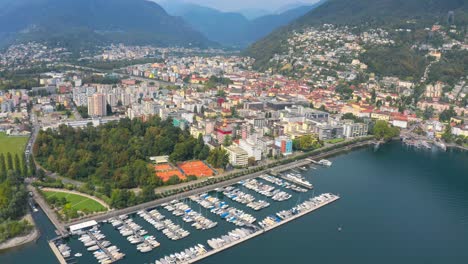 Establishing-high-aerial-shot-of-Locarno-cityscape-with-marina-lake,-Switzerland