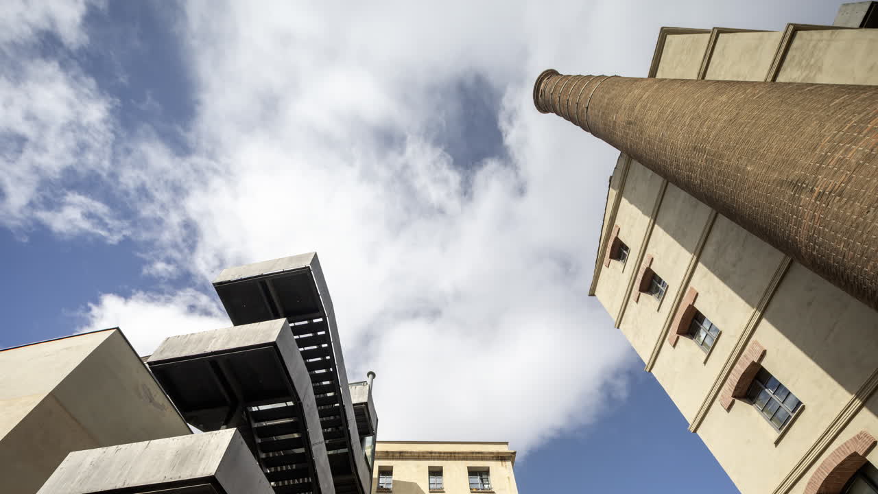 Old factory chimney and apartment buildings in barcelona