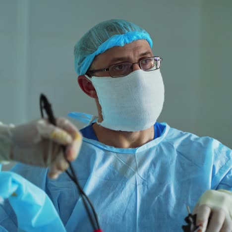 portrait of a male doctor in mask. surgeons perform an operation in the hospital. medical operation. professional specialist during surgery.