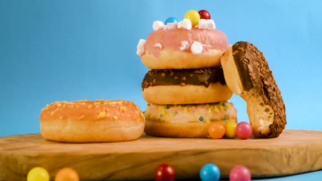 steady shot of a few donuts and a donut getting picked up