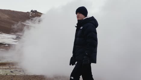 guy suddenly appear from white dense smoke cloud in icelandic landscape