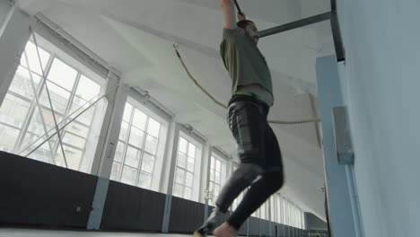 man with prosthetic leg doing hanging leg raise