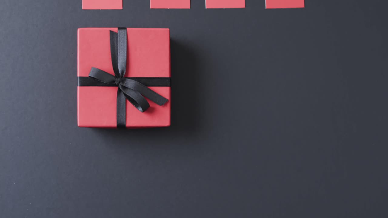 video de etiquetas de regalo con caja de regalo roja con cinta y espacio de copia en fondo negro