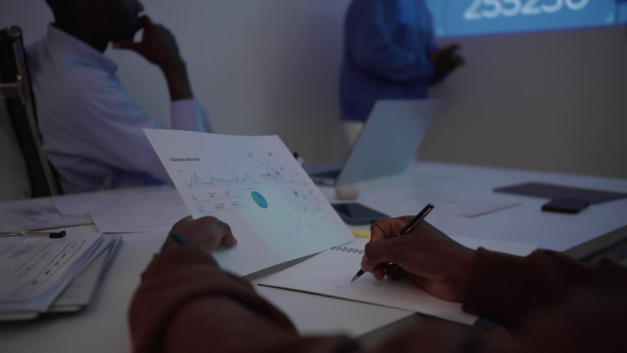 Investor Checking Trading Assets while Meeting with Colleagues at Crypto Office