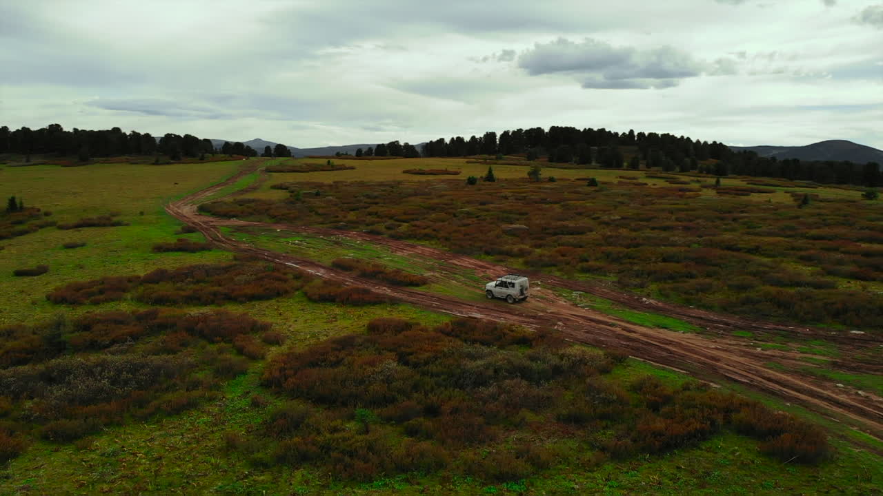 Off-Road Vehicle on a Dirt Road in a Rural Landscape