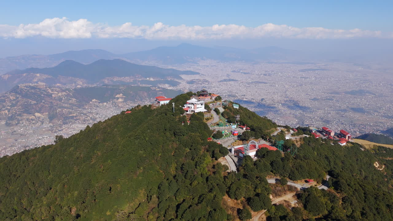 Drone shot flying around the Chandragiri hill, sunny day in Kathmandu, Nepal
