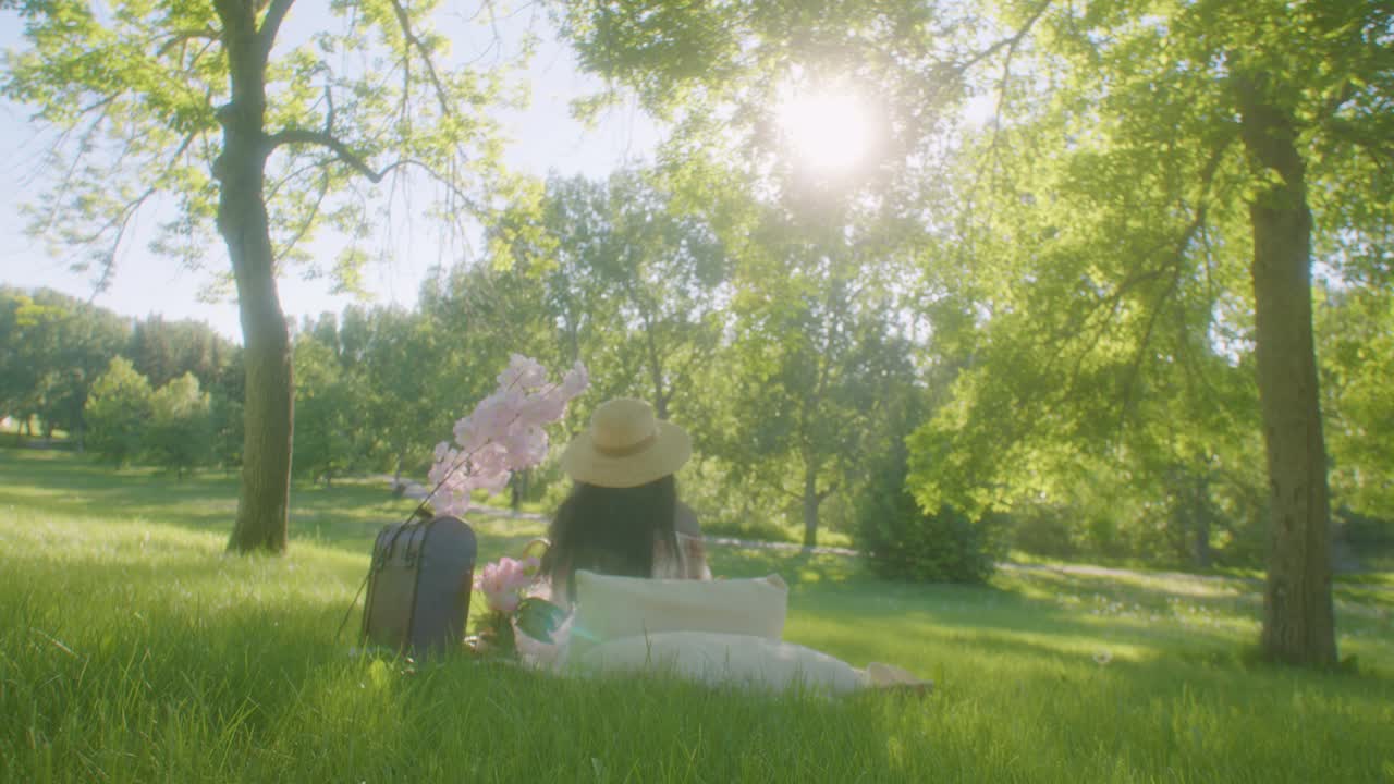 레이디는 즐거운 날, 연합 공원에서 큰 나무 그늘에서 피크닉을 즐깁니다.