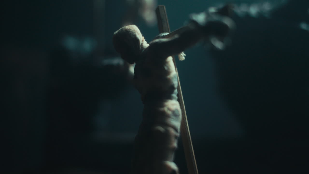 A miniature mummified dolls hanging on the gallows at night