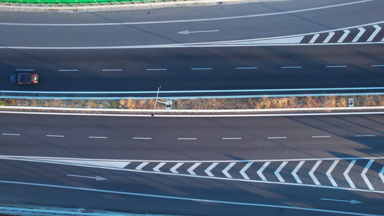 Aerial view of white road markings guiding traffic on ring road highway, transport infrastructure scene