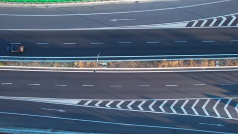 Aerial view of white road markings guiding traffic on ring road highway, transport infrastructure scene