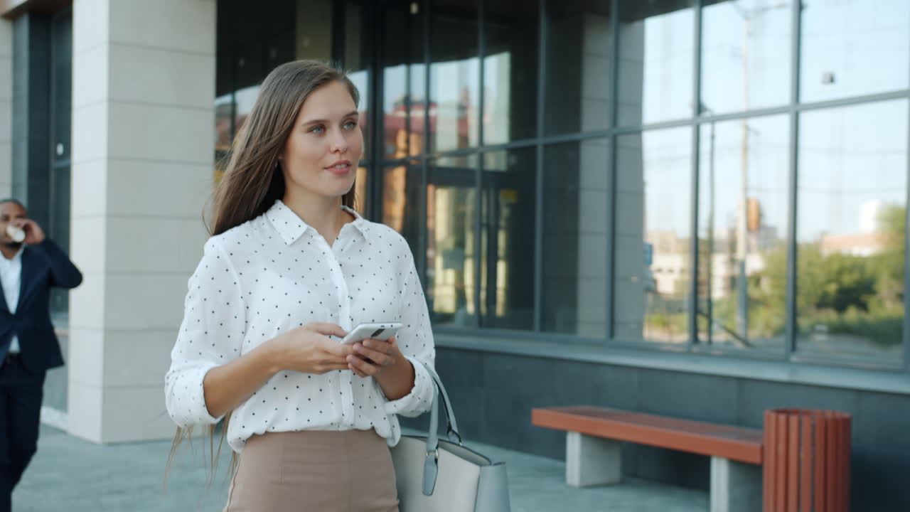 Businesswoman using smartphone in an urban setting