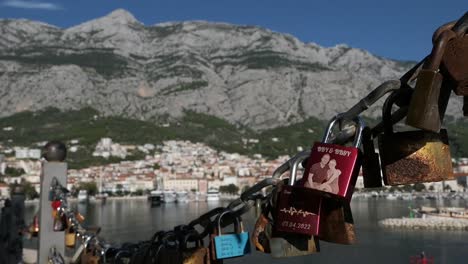 love locks and view of seaside town by mountains, symbol of couple in love