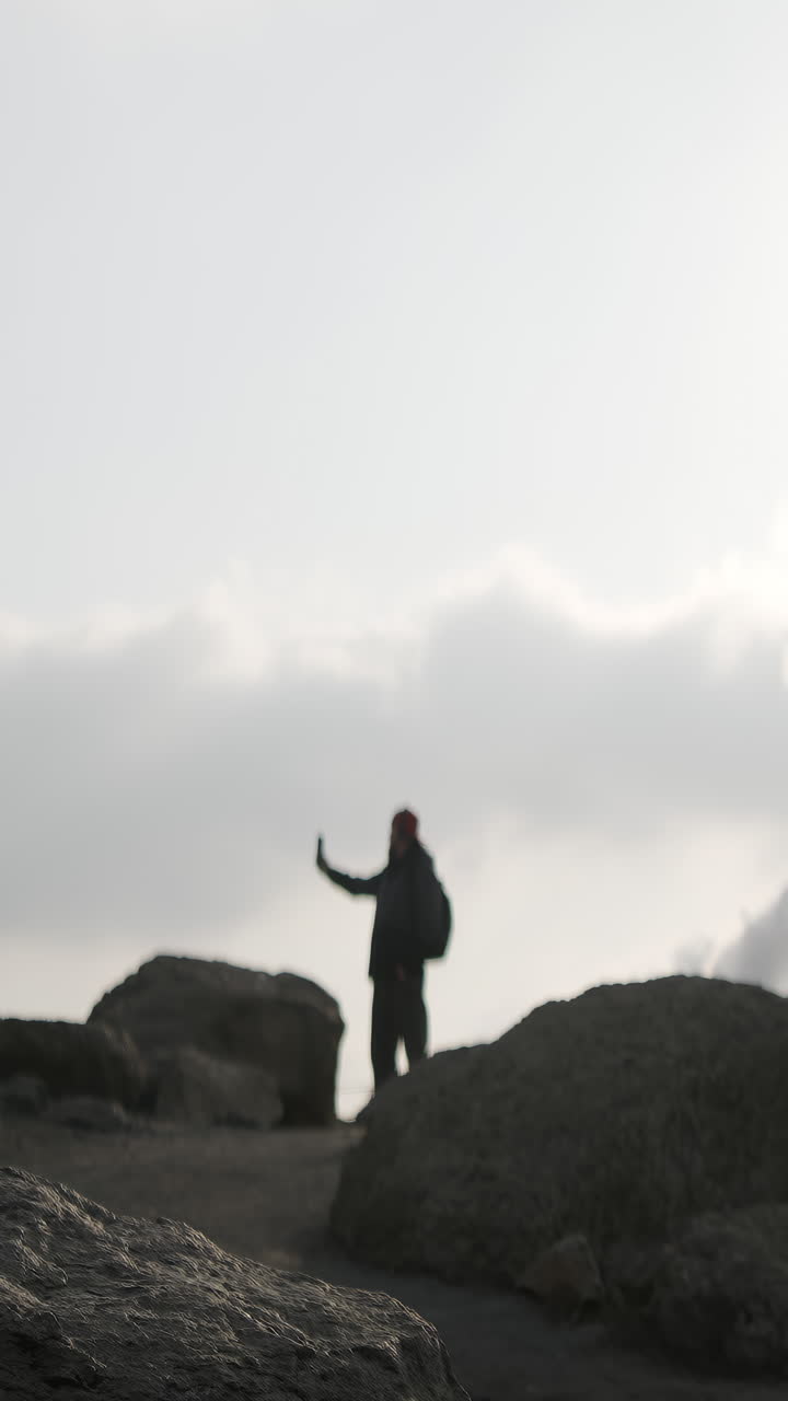 Blurred Silhouette of a Person on a Rocky Landscape