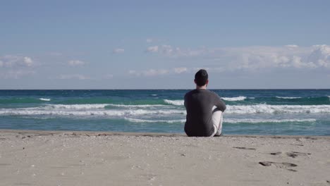 Hombre-Pensativo-Mirando-El-Mar-Con-Muchas-Olas