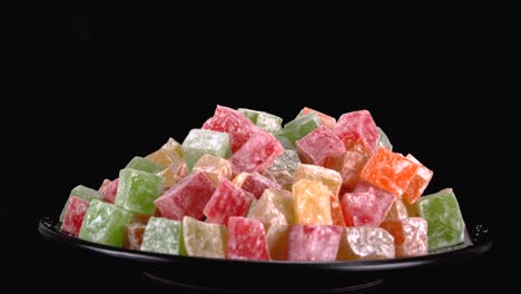 vibrant turkish delight sweets against black backdrop