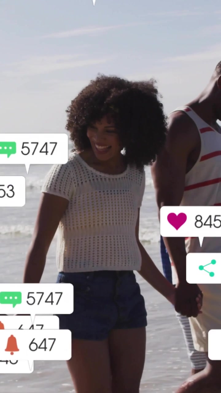 Vertical video: Woman walking family in sea, social icons popping over them, rising, fading for ads