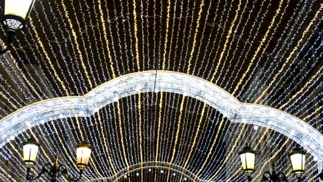 festive illuminated street archway at night