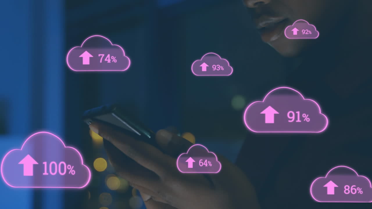 Animation of cloud upload icons against african american woman using smartphone at office