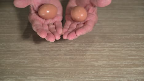 senior-citizen-hands-showing-two-nest-eggs-for-retirement