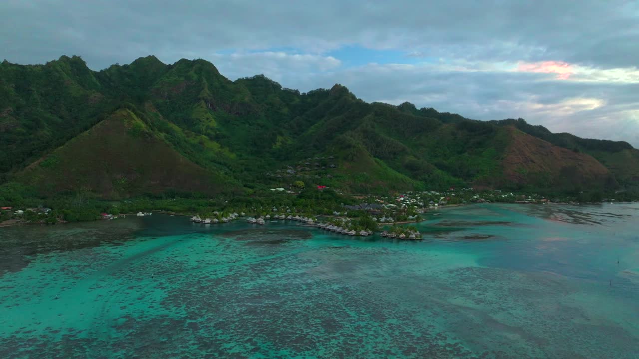 Bungalows Cooks Opunohu Bay Moorea island French Polynesia aerial drone morning boats Passe clear skies lagoon coral reef waves Mount Mauaroa Tohivea Rotui Haapiti Pacific Ocean backward pan up motion